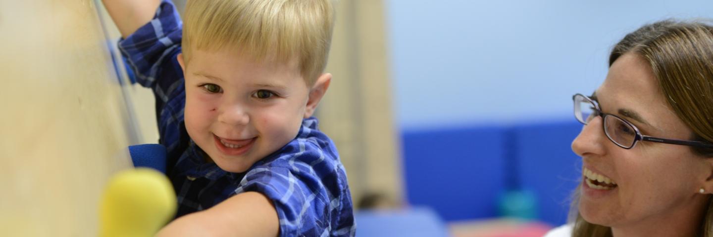 Child climbing on a wall during therapy