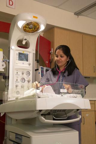 Dr Charvarkar checking an infant in the special care nursery.