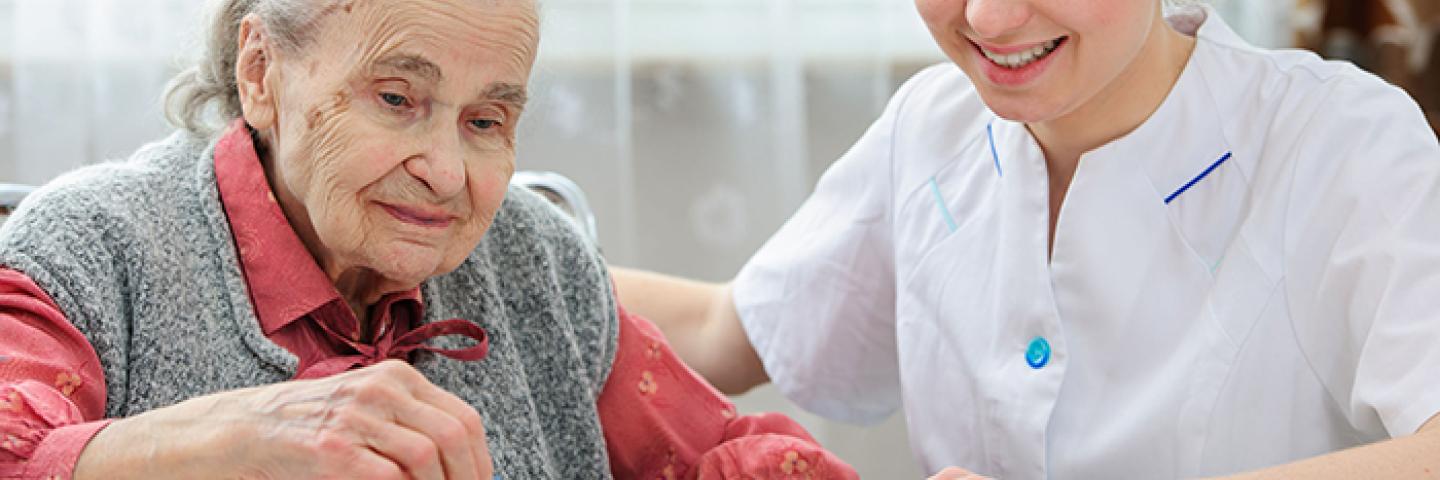 Medical staff working with senior on a puzzle 