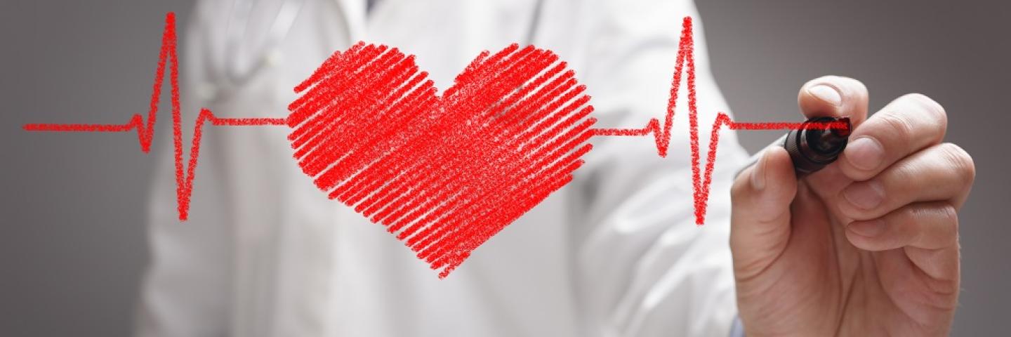 Physician Drawing a Heart on clear glass