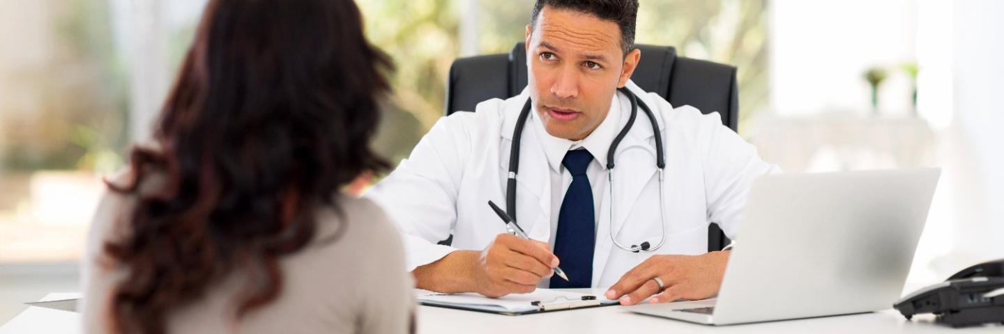 Doctor with patient sitting at desk